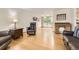 Spacious living room featuring hardwood floors, comfortable seating, and abundant natural light at 845 S 9Th Ave, Brighton, CO 80601