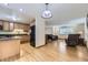 Open-concept living space with hardwood floors, connecting the kitchen and living room at 845 S 9Th Ave, Brighton, CO 80601
