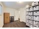 Finished basement storage room with shelving and neutral carpet at 845 S 9Th Ave, Brighton, CO 80601