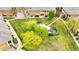 Aerial view showcases a beautiful community park with winding pathways, pergolas, lush lawns and mature trees at 1703 Whitehall Dr # 5I, Longmont, CO 80504