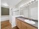 Bright bathroom featuring modern sink, shower, and bathtub at 1703 Whitehall Dr # 5I, Longmont, CO 80504