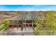 Elevated exterior showcasing townhomes with red garages framed by mature trees and landscaping against a clear blue sky at 1703 Whitehall Dr # 5I, Longmont, CO 80504