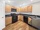 Bright kitchen featuring stainless steel sink, maple cabinets and black appliances at 1703 Whitehall Dr # 5I, Longmont, CO 80504