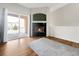Bright living room with a cozy fireplace and a sliding door leading to a balcony offers great indoor/outdoor living at 1703 Whitehall Dr # 5I, Longmont, CO 80504
