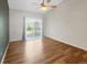 Sun-filled main bedroom with hardwood floors and a sliding glass door offers a peaceful retreat at 1703 Whitehall Dr # 5I, Longmont, CO 80504
