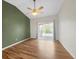 Sun-filled bedroom with hardwood floors, a ceiling fan, and a sliding glass door offers a peaceful retreat at 1703 Whitehall Dr # 5I, Longmont, CO 80504