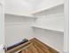Spacious walk-in closet with shelving and wood flooring at 1703 Whitehall Dr # 5I, Longmont, CO 80504