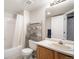 Bathroom featuring a tub and shower with curtain, toilet, and sink with mirror and vanity at 12555 E Tennessee Cir # 302, Aurora, CO 80012