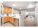 Kitchen featuring light wood cabinets, stainless steel appliances, white countertops and open layout to living area at 12555 E Tennessee Cir # 302, Aurora, CO 80012
