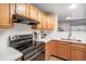 Kitchen featuring light wood cabinets, stainless steel appliances and a pass through to the living area at 12555 E Tennessee Cir # 302, Aurora, CO 80012