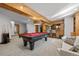 Recreational basement area featuring a pool table, bar with seating, and plenty of space for activities at 8912 Little Raven Trl, Niwot, CO 80503