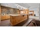 Basement bar area with wood paneling, stone backsplash, countertops, and wine rack feature at 8912 Little Raven Trl, Niwot, CO 80503