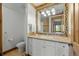 Bright bathroom featuring a white vanity, colorful tile mirror and flooring, with wood trim accents at 8912 Little Raven Trl, Niwot, CO 80503