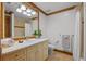 Bright bathroom featuring neutral counters and cabinetry with tile flooring and shower/tub surround at 8912 Little Raven Trl, Niwot, CO 80503