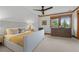 Bright bedroom with natural wood trim, comfortable bed, and scenic view at 8912 Little Raven Trl, Niwot, CO 80503