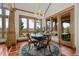 Bright dining area with wood trim, chandelier, and scenic views from multiple windows at 8912 Little Raven Trl, Niwot, CO 80503