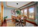 The dining room features wood floors, decorative lighting, and beautiful natural light from the windows at 8912 Little Raven Trl, Niwot, CO 80503