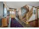 Inviting foyer with staircase, wood accents, and ample natural light at 8912 Little Raven Trl, Niwot, CO 80503