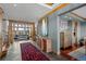 Bright foyer with wood trim, tiled floors, views of the living room, and decorative furnishings at 8912 Little Raven Trl, Niwot, CO 80503
