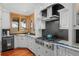 This modern kitchen includes white cabinets, stainless steel appliances, and granite countertops at 8912 Little Raven Trl, Niwot, CO 80503