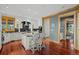 Modern white kitchen features an island with seating and stainless steel appliances at 8912 Little Raven Trl, Niwot, CO 80503