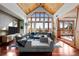 Spacious living room with vaulted wood ceilings, large picture windows, and comfortable seating at 8912 Little Raven Trl, Niwot, CO 80503