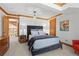 Comfortable primary bedroom featuring soft lighting and carpeted floors. Includes an attached dressing area at 8912 Little Raven Trl, Niwot, CO 80503