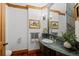 Chic powder room featuring stone sink, elegant mirror and modern fixtures at 8912 Little Raven Trl, Niwot, CO 80503
