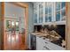 Elegant wet bar with stylish backsplash, marble countertop, and glass shelving at 8912 Little Raven Trl, Niwot, CO 80503