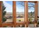 Expansive window frames a picturesque view of rolling hills and clear blue sky at 8912 Little Raven Trl, Niwot, CO 80503