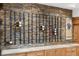 Home wet bar featuring stylish stone accents and wood cabinetry with a built-in wine rack at 8912 Little Raven Trl, Niwot, CO 80503