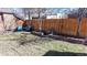 Backyard seating area with privacy fence and mature landscaping at 1560 Hudson St, Denver, CO 80220