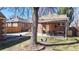 Large backyard with covered patio, mature trees, and plenty of space for outdoor activities at 1560 Hudson St, Denver, CO 80220