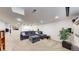 Spacious basement living room features neutral carpet and a comfortable grey sectional sofa at 1560 Hudson St, Denver, CO 80220