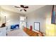 Bedroom showcasing neutral walls, hardwood floors and a view into the updated kitchen at 1560 Hudson St, Denver, CO 80220