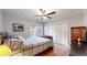 Bedroom with hardwood floors, neutral walls, ceiling fan, a double door closet and bright natural light at 1560 Hudson St, Denver, CO 80220