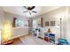 Bedroom featuring a ceiling fan, hardwood floors, neutral walls and natural light from two windows at 1560 Hudson St, Denver, CO 80220