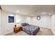 Basement bedroom with neutral carpet, egress window, and adjacent closets at 1560 Hudson St, Denver, CO 80220