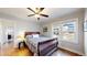 Cozy bedroom with hardwood floors, neutral walls, ceiling fan and bright natural light through multiple windows at 1560 Hudson St, Denver, CO 80220