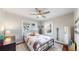 Bedroom with hardwood floors, ceiling fan, and two bright windows for natural light at 1560 Hudson St, Denver, CO 80220