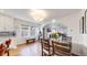 Well-lit dining area with hardwood floors and view to the living room and fireplace at 1560 Hudson St, Denver, CO 80220