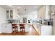 Contemporary kitchen featuring white cabinetry, stainless steel appliances, granite countertops, and hardwood floors at 1560 Hudson St, Denver, CO 80220