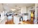 Bright kitchen with stainless steel appliances, white cabinets, and a center island open to the living area at 1560 Hudson St, Denver, CO 80220