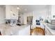 Bright, modern kitchen featuring stainless steel appliances, granite countertops, and white cabinetry at 1560 Hudson St, Denver, CO 80220