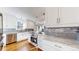 Bright kitchen featuring granite countertops, mosaic backsplash, stainless steel appliances and hardwood floors at 1560 Hudson St, Denver, CO 80220