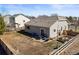 Aerial view of a backyard with a patio seating area and garden bed surrounded by a wooden fence at 19302 E 58Th Pl, Aurora, CO 80019