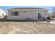Back of home with windows, sliding glass door, patio area with furniture and xeriscaped yard at 19302 E 58Th Pl, Aurora, CO 80019