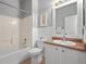 Bright bathroom featuring a shower-tub combo and white vanity at 19302 E 58Th Pl, Aurora, CO 80019