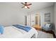 Comfortable bedroom with a ceiling fan, a chair with accent pillow, and ensuite bathroom access at 19302 E 58Th Pl, Aurora, CO 80019