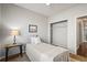 Cozy bedroom with single bed, lamp, and open closet at 19302 E 58Th Pl, Aurora, CO 80019